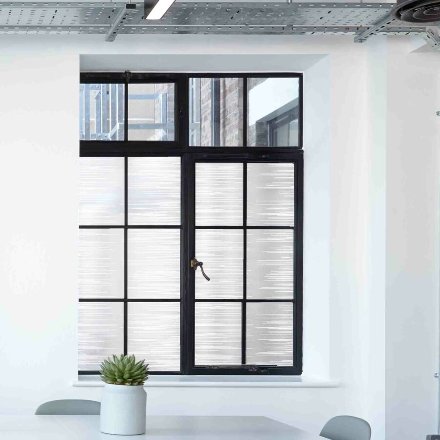 Privacy window film in a contemporary abstract linear pattern shown on multi-paned glass.