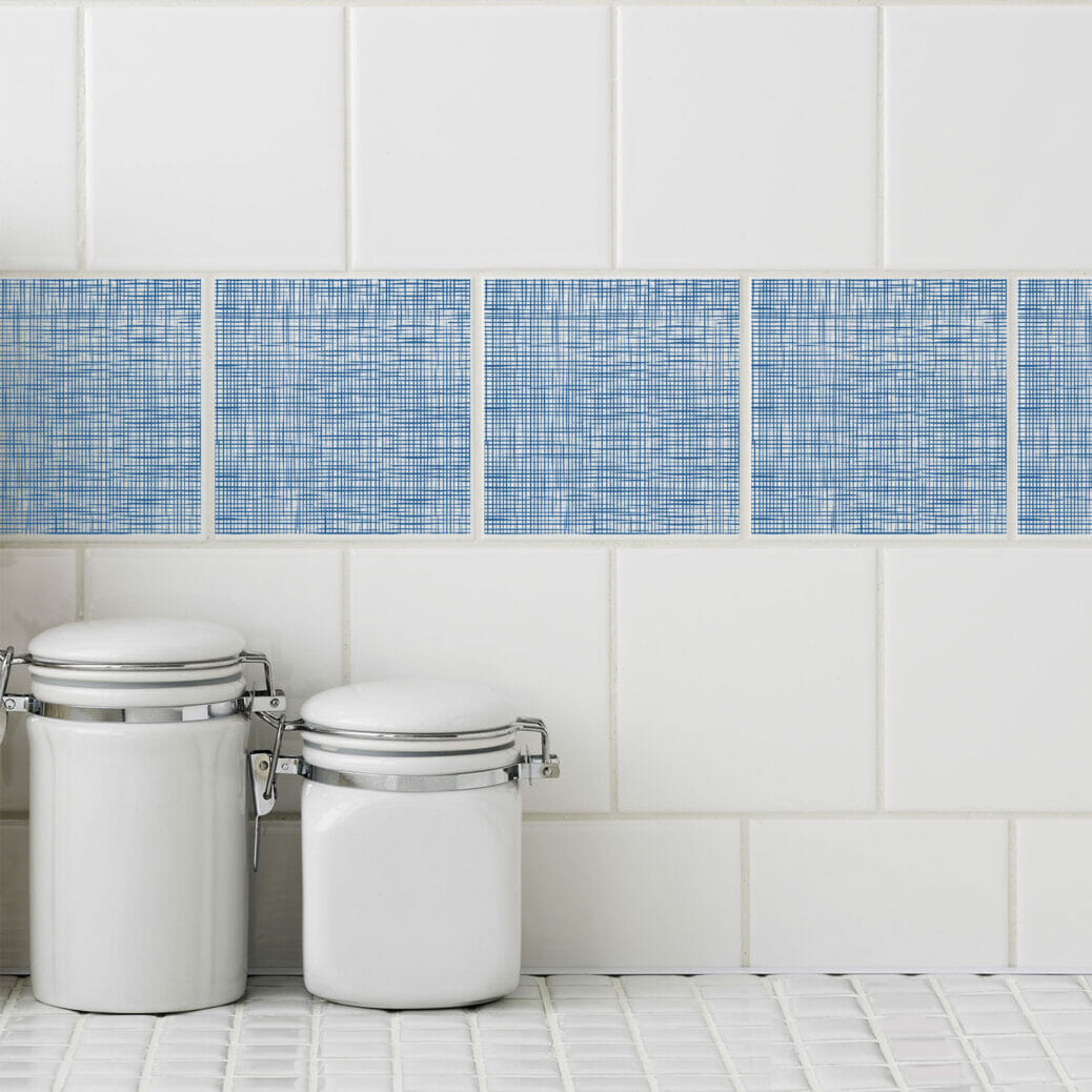 Tile stickers on white tiles mimic the look of textured linen.