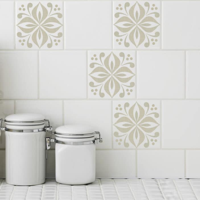 Floral medallion tile stickers in a soft sand color cover white tiles in a kitchen setting.