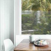 Dining table with fresh flowers and breakfast tray with coffee c