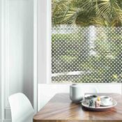 Dining table with fresh flowers and breakfast tray with coffee c