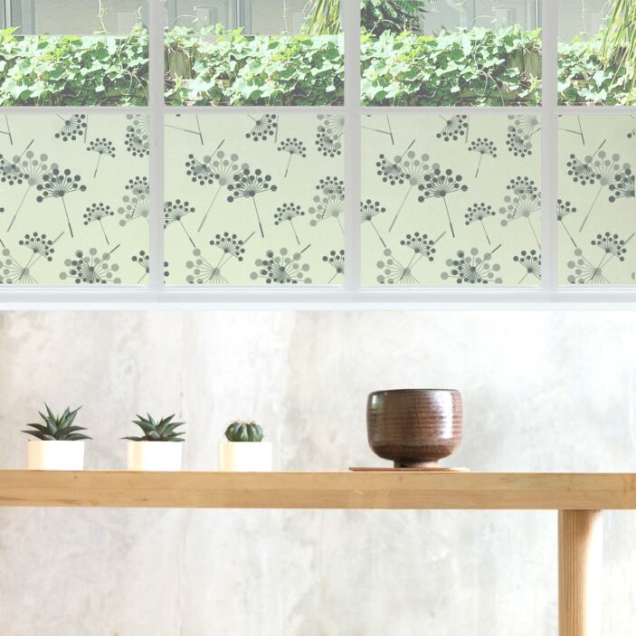 Abstract dandelions adorn a piece of window privacy film in a soft-hued zen room.