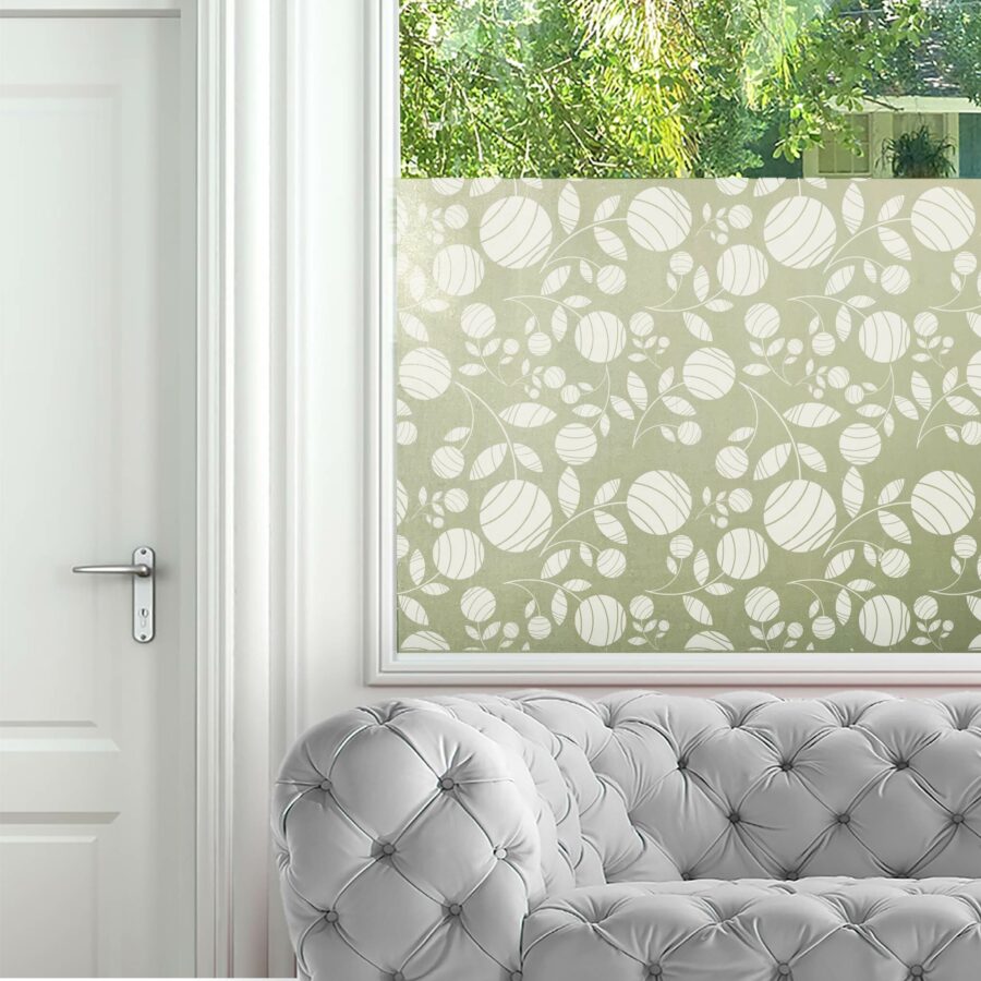 Window privacy film adorns a living room window. The design features abstract flower blooms with leaves.